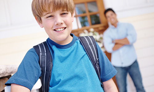 Boy with backpack leaving home